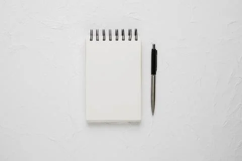 High angle view white blank spiral notepad with ballpoint pen Stock Photos