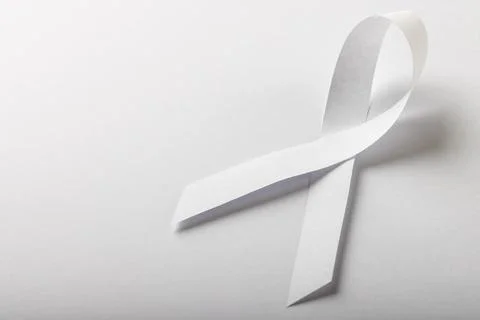 High angle view of white lung cancer awareness ribbon isolated against white Stock Photos