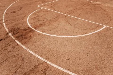 High angle view of white painted game lines on a reddish-brown asphalt outd.. Stock Photos