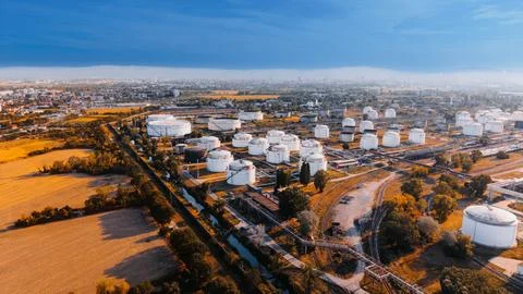 High angle view of white petroleum storage tanks beside rail tracks. Large .. Stock Photos