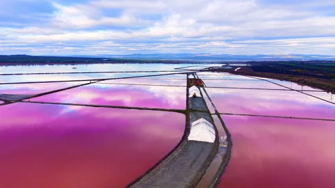 High angle view of white salt piles and pink pans Stock Footage 330486864