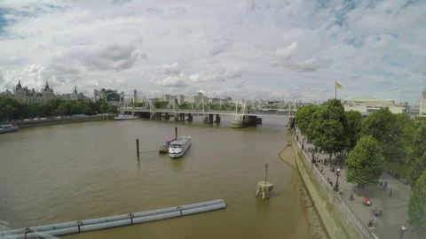 High angle view from window of Thames river and footbridge with cloudy sky an Stock Footage 85762392