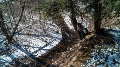 High Angle View of Winter Stream and Person Hiking on Forest Ridge in Snow Stock-Fotos