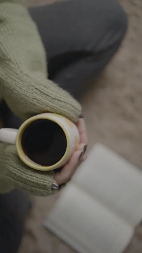 High angle view of woman hands drinking hot coffee and reading a book while.. Stock Footage 284576370