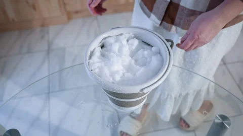 High Angle View Of Woman Placing Snow Bucket On Glass Table Stock Footage 309046160