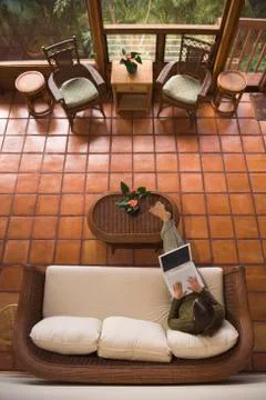 High angle view of woman using laptop on sofa 库存照片