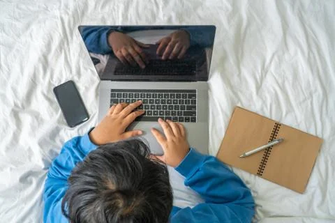 High angle view of woman using laptop on bed Foto stock