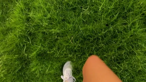High angle view woman walking on the grass Stock Footage 132872048