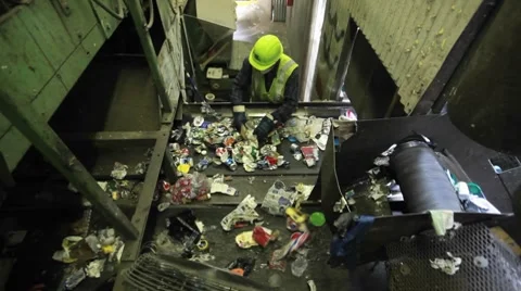 High angle view of workers sorting trash at a recycling center. Stock Footage 8524323