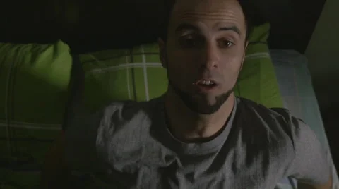 High angle view of young handsome man waking up scared Video stock 59843052