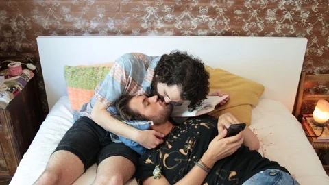 High angle view of young homosexual couple kissing in bedroom at home Stock Footage 114859462