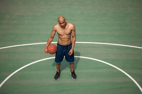 High angle view of young man, male basketball player playing basketball at Stock Photos
