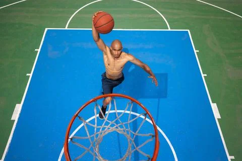 High angle view of young man, male basketball player playing basketball at Stock Photos