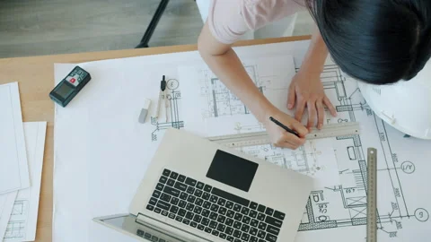 High angle view of young specialist drafting construction plan working with Stock Footage 157554425