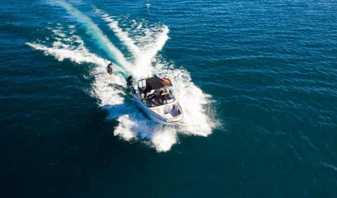 High Angle Of Wake Surfing Boat With Two Surfers Stock Photos