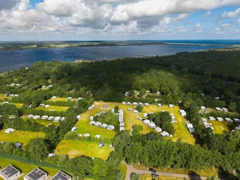 High angle wide horizontal aerial drone photograph of campsite, forest Stock Photos