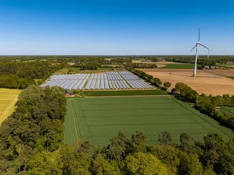 High angle wide horizontal aerial drone photograph of commercial polytunnel Stock Photos