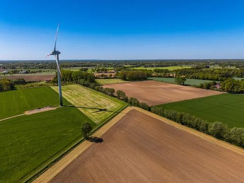 High angle wide horizontal aerial drone photograph of wind turbine, long Stock Photos