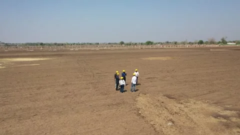 A high-angle wide perspective showing a small group of infrastructure developers 動画素材 337191226