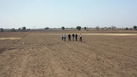 A high-angle wide perspective showing a small group of land developers standing Stock Footage 337199061