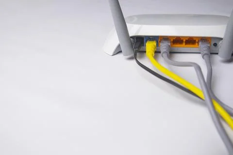 High-angle, wide shot of a white wireless router back panel with multiple E.. Stock Photos