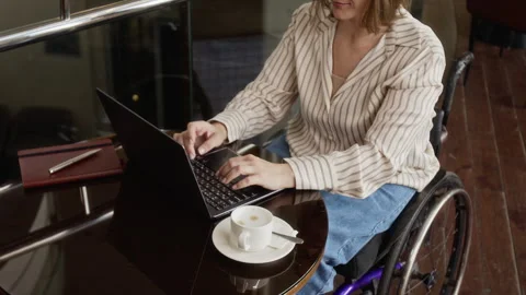 High Angle of Woman with Disability Working on Laptop Computer at Cafe Table Stock Footage 343785849