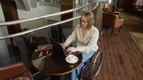 High Angle of Woman with Disability Working on Laptop Computer in Modern Cafe Stock Footage 343790148