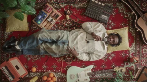 High Angle of Young Man Singing in Mic on Vintage Rug with Music Equipment Video stock 339849333