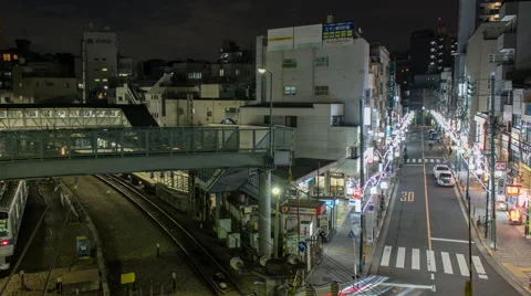 High angle zoom out time lapse of busy area near Yoyogihachiman station in Tokyo Stock Footage 50504272
