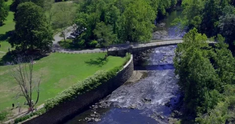 High Angled View down the bridge crossing the small creek with Green forest. 4K Stock Footage 139151946