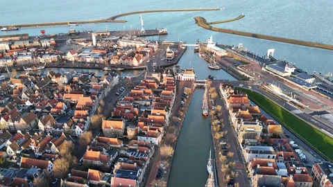 High arc around harbor city entrance from angled overhead view Stock Footage 331843053