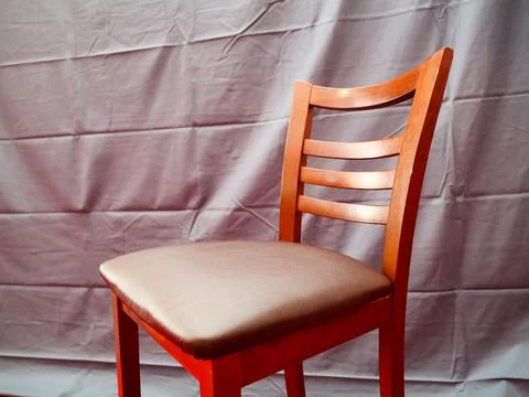 High bar stool in the interior against the background of gray fabric Stockfoto's