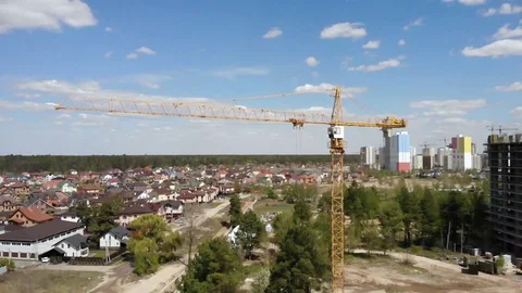 High building construction site. Big industrial tower crane with blue sky amd Stock Footage 129597631