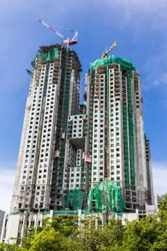 High building under construction with working crane Stock Photos