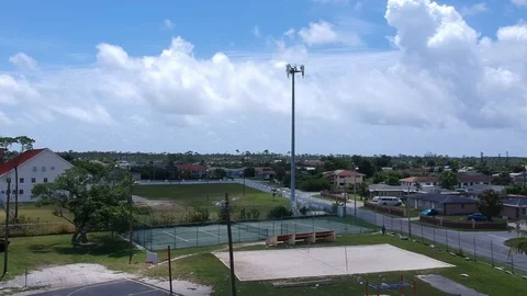 High Cell Tower Overlooking Homes in Residential Community, Bahamas Aerial Stock Footage 90105684
