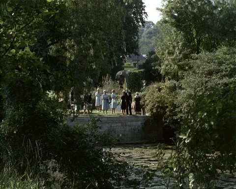 High class people walking through the gardens at Glyndebourne, Sussex, UK 1964 Video stock 132325955