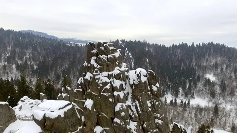 High cliff and rocks in the mountains covered in snow Stock Footage 129421953