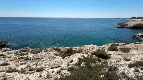 High Cliffs and Golumbera Cave at Velika Kolumbarica Beach on Cape Kamenjak Stock Footage 336708320