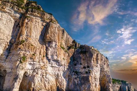 High cliffs with forest and rocks on shore of Corfu island Stock Photos