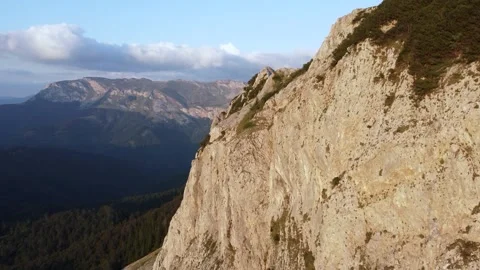 High cliffs on the mountain, aerial drone view. Steep rocks at sunset. Stock Footage 321135867