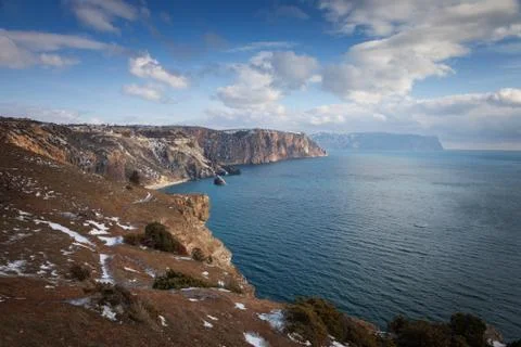 High cliffs over the sea under a blue sky with clouds. Fiolent. Stock Photos