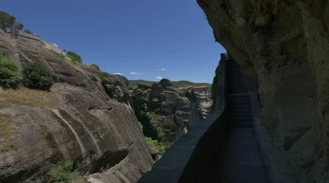 High cliffs visible from a stone stairway leading to a monastery in Meteora Stock Footage 67717737