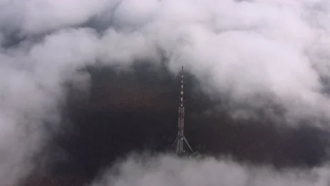 High communications tower antenna rises above the clouds Stock Footage 154000614