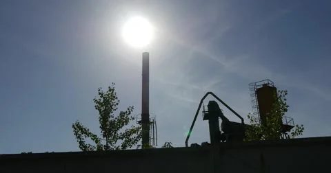 High Concrete Wall With Rolls of Bob Wire at Oil Storage Buildings With a White Stock Footage 53090847