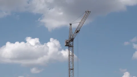 High construction crane on background of blue cloudy sky Stock Footage 129793151
