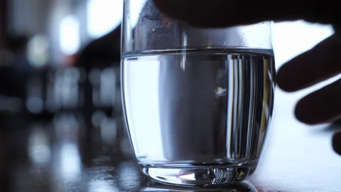 High contrast man drinks water slow motion leaves fingerprint on glass Stock Footage 102801069