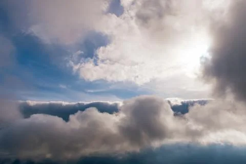 The high contrast view of a dramatic moody sky with several layers of clouds  Stock Photos