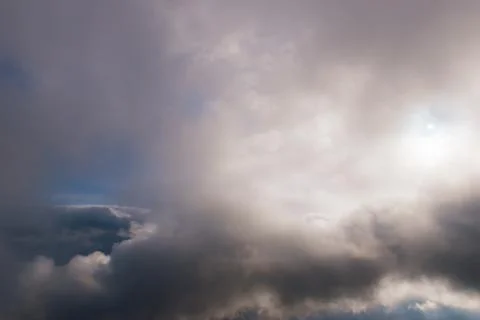 The high contrast view of a dramatic moody sky with several layers of clouds  Stock Photos