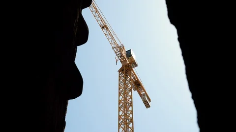 High crane is on construction site against blue sky on summer day. 4K Video stock 124631186