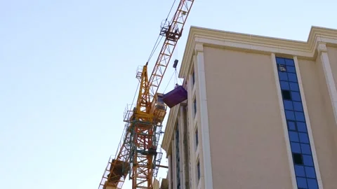 High crane for house building at the construction site on blue sky background Video stock 262228844